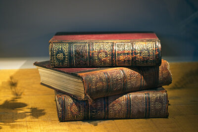 stack of three older books